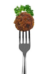 Meatball with herbs on a fork isolated over white