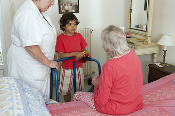 grand son visiting her grand mother with care giver