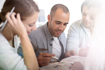 Obraz premium Young people in college studying together in library