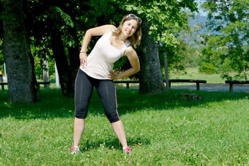 sporty young woman makes stretching exercises