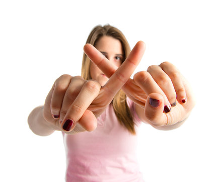 Blonde girl doing NO gesture over white background