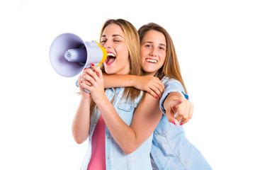 Girls shoutimg with megaphone over white background