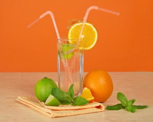 Drink, ripe orange, juicy lime and napkin