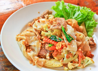 Stir fried noodles with egg, pork, green vetgetables and sauce