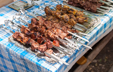 Fresh portion of shish kebab (shashlik) on table outdoor