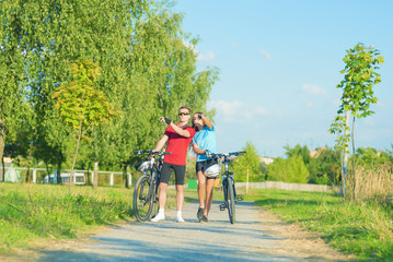 Young Caucasian Couple Having a walk with Bikes