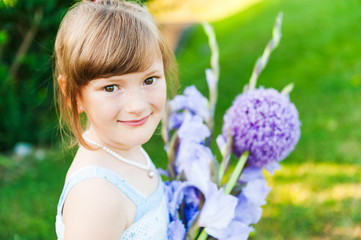 Fototapeta premium Outdoor portrait of a cute little girl