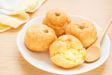 Cream puffs on white plate