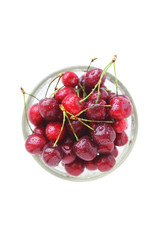 Cherry red with drops in a glass bowl on a white background