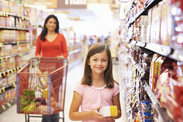 Mother and daughter shopping in supermarket