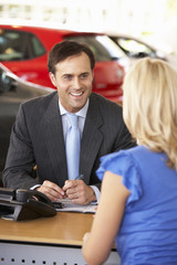 Man working in car showroom