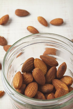 Overhead Of Almonds In Mason Jar With White Rustic Background