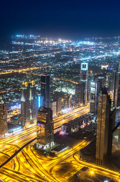 Dubai downtown night scene with city lights,