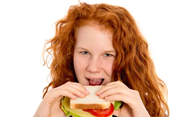 Deurstickers red haired girl eating sandwich © Firma V