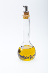 Thyme infused olive oil over white background