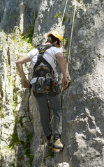 young man climbing a rock wall