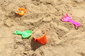 Fototapeta na wymiar Colorful toys for children's sandboxes on the sea beach