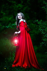 beautiful woman with red cloak  in the woods