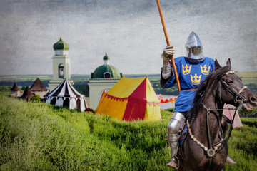 Armored knight on warhorse over old medieval castle