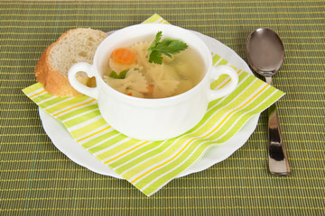 Soup in white plate and bread