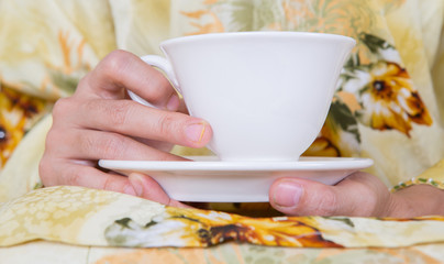 Female hands holding a cup of tea