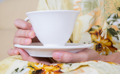 Female hands holding a cup of tea