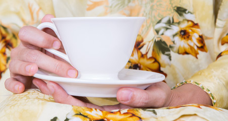 Female hands holding a cup of tea
