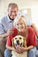 Retired couple at home with dog