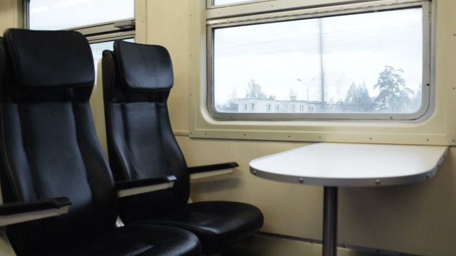 Two empty seats with table in the moving train
