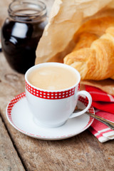 Breakfast setting: cup of coffee and croissants