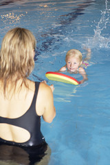 Young girl learning to swim
