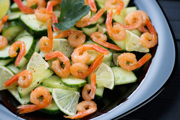 Roasted shrimps, cucumbers and lime salad, studio shot