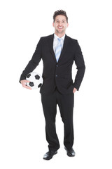 Confident Young Businessman Holding Soccer Ball