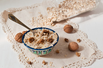 Porridge with walnuts on lace napkin.