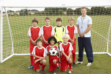 Junior football team and coach portrait