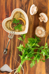 Mushroom casserole  with fresh parsley on brown wooden board
