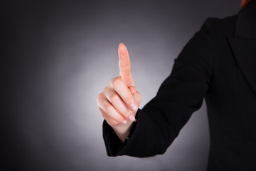 Businesswoman Touching Transparent Screen