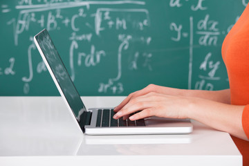 University Student Using Laptop In Classroom