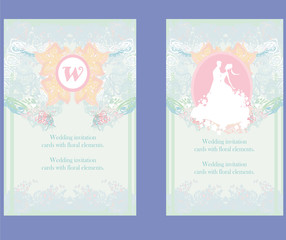 Fototapeta premium Wedding invitation cards with floral elements.