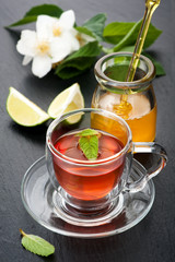 Herbal tea with mint, jasmine flowers and honey.