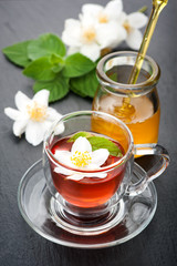 Herbal tea with mint, jasmine flowers and honey.
