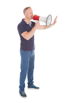 Man Screaming Into Bullhorn While Pointing Away