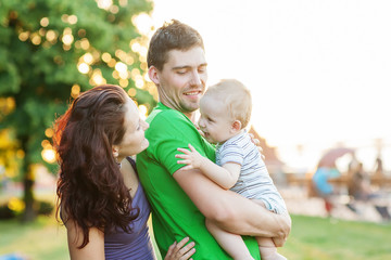 Fototapeta premium Young Attractive Parents and Child Portrait Outdoors