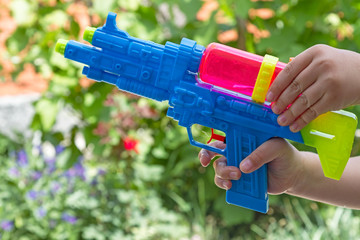 Child with a water pistol outdoors
