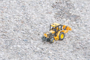 toy tractor on the cobblestone floor