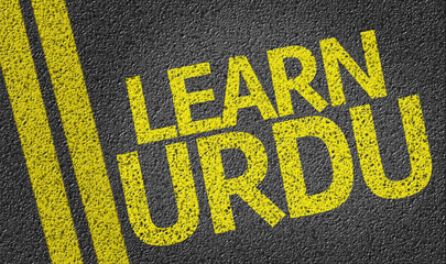 Obraz premium Learn Urdu written on the road