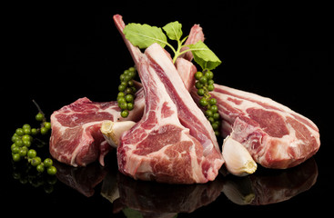 Raw lamb chops with spices and herbs
