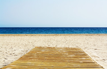Wooden floor on empty beautiful beach