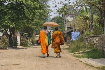 Fotobehang Monks with umbrella in Luang Prabang, Laos.. © NICOLA