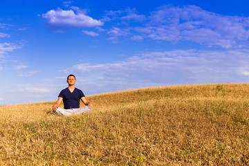 Naklejka na ściany i meble The peaceful scenery of a man meditating in the lotus position.